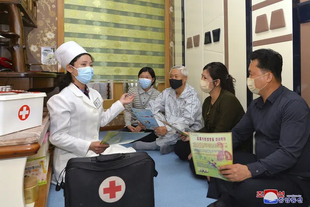 In this photo provided by the North Korean government, a doctor visits a family during an activity to raise public awareness of the COVID-19 prevention measures, in Pyongyang, North Korea Tuesday, May 17, 2022.  Independent journalists were not given access to cover the event depicted in this image distributed by the North Korean government. The content of this image is as provided and cannot be independently verified. Korean language watermark on image as provided by source reads: “KCNA” which is the abbreviation for Korean Central News Agency. (Photo by Korean Central News Agency/Korea News Service via AP Photo)