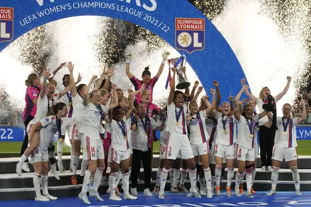 Olympique Lyon players celebrate with the trophy after winning the Women's Champions League final soccer match between Barcelona and Olympique Lyonnais at Allianz Stadium in Turin, Italy, Saturday, May 21, 2022. (Photo by Alessandra Tarantino/AP Photo)