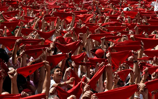 Revellers hold up red scarves during the Chupinazo, the official start of the San Fermin festival in Pamplona, Spain on July 6, 2017. (Photo by Eloy Alonso/Reuters)