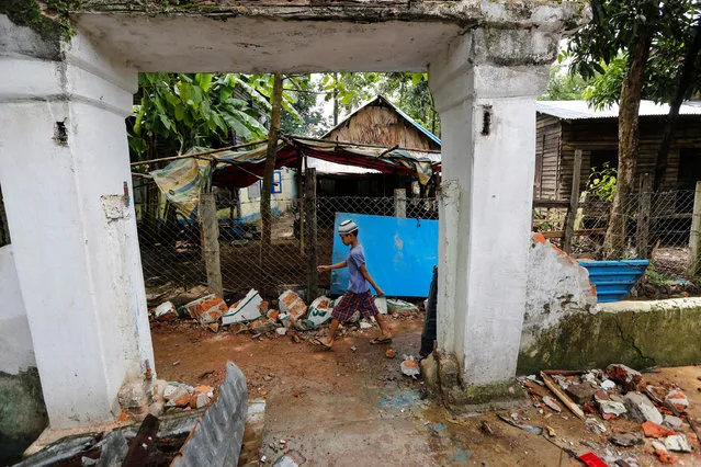 A boy walks past the entrance of a destroyed mosque after a group of men attacked it in the first serious outburst of inter-religious violence in months in the village of Thayethamin outside Yangon, Myanmar June 24, 2016. (Photo by Soe Zeya Tun/Reuters)
