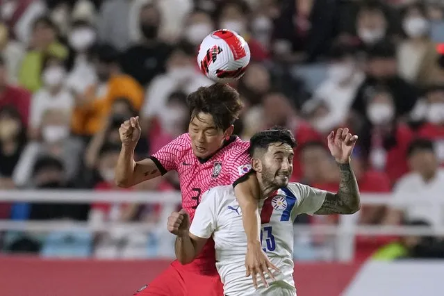 South Korea's Kim Jin-su, left, fights for the ball with Paraguay's Mathias Villasanti during their friendly soccer match at Suwon World Cup stadium in Suwon, South Korea, Friday, June 10, 2022. (Photo by Lee Jin-man/AP Photo)