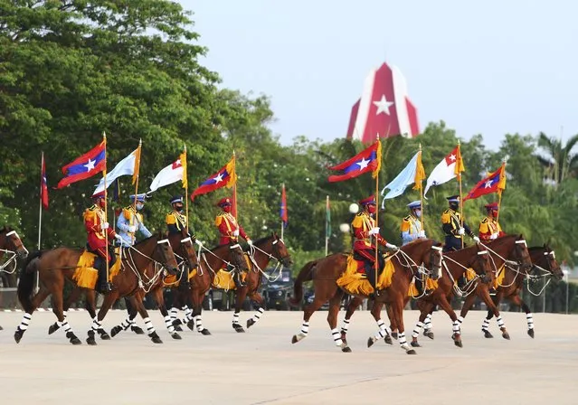 Myanmar's military demonstrates with horses during a parade to commemorate Myanmar's 77th Armed Forces Day in Naypyitaw, Myanmar, Sunday, March 27, 2022. The occasion commemorates resistance against Japanese occupiers during World War II, and is a show of strength as the military battles armed resistance to its takeover last year that ousted the elected government of Aung San Suu Kyi. (Photo by Aung Shine Oo/AP Photo)