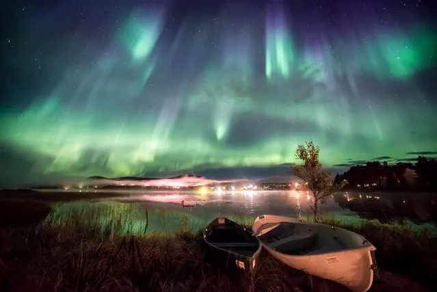 Kayaks, Äkäslompolo, Finland. Vibrant auroras in varying hues of blue and green swirl across the southern sky over lake Äkäslompolo in Finland. The photographer remembers the difficulty of choosing where to capture the phenomenal display as the night sky was overtaken by the light show. (Photo by Marcus Kiili/National Maritime Museum)