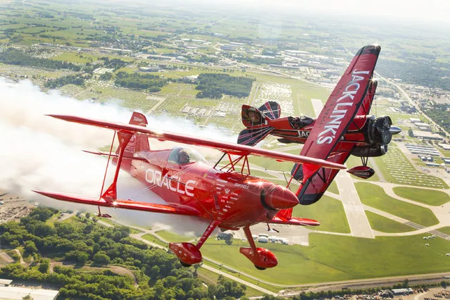 Renowned aerobatic pilots Sean D. Tucker, flying the Oracle Challenger III, and Jeff Boerboon, flying the Jack Link's Screamin' Sasquatch, take to the skies over EAA's 2015 AirVenture Oshkosh, on Monday, July 20, 2015 in Oshkosh, Wis. (Photo by Matt Ludtke/AP Images for Jack Link's)