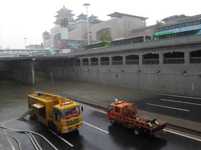 Rescue vehicles drain water out from a flooded tunnel next to the Beijing West Railway Station during a heavy rainfall in Beijing, China, July 20, 2016. (Photo by Reuters/Stringer)