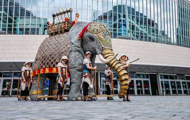 Artists in costumes present an artificial five-meter tall elephant to promote the upcoming opera show “AIDA – The Arena Opera Spectacle” in Berlin, Germany, 10 October 2023. In spring 2024, “AIDA – The Arena Opera Spectacle” will have its world premiere in Hamburg on 02 February. Following the premiere, the production will embark on a tour across Germany and other various cities in Europe. (Photo by Hannibal Hanschke/EPA/EFE)