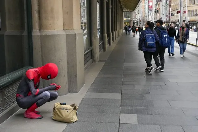 A man dressed in a “spiderman” suits checks his phone in the central business district of Sydney, Australia, Friday, September 2, 2022. (Photo by Mark Baker/AP Photo)
