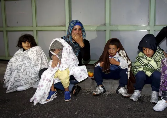 Migrants sit at the Austrian-Hungarian border station of Hegyeshalom, Hungary, September 5, 2015. (Photo by Heinz-Peter Bader/Reuters)