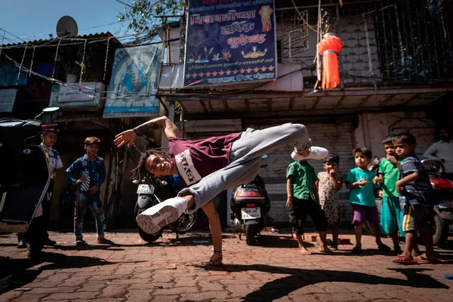 Brasilian dancer Mateus Melo performs in the streets during a photo session in Mumbai on November 7, 2019, ahead of the Red Bull BC One world championship. Mumbai will host the world’s most prestigious one-on-one battle. Mumbai will see 16 of the world’s best breakers go head to head to take the belt and earn the title of Red Bull BC One World Champion. (Photo by Lionel Bonaventure/AFP Photo)