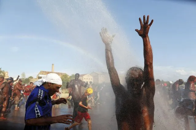 A rainbow forms as a reveller covered in paint is sprayed with water, during the annual Cascamorras festival in Guadix, southern Spain September 9, 2015. (Photo by Marcelo del Pozo/Reuters)