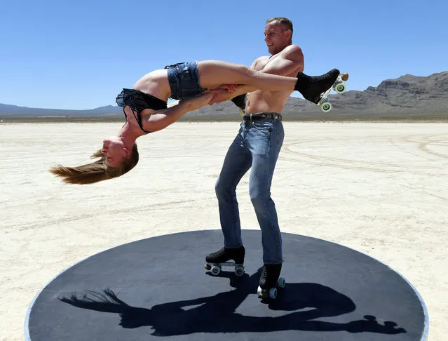 Anastasiia Bogoslova and her husband Pavel Bahaslou of the roller-skating duo Wings Dream from the “EXTRAVAGANZA – The Vegas Spectacular” show at Bally's Las Vegas Hotel & Casino perform for a promotional video at Jean Dry Lake amid the spread of the coronavirus on May 24, 2020 near Jean, Nevada. The new show was only able to put on one preview performance on March 14 before the COVID-19 pandemic caused the Las Vegas Strip resorts to close their entertainment venues. Since the shutdown, Las Vegas entertainers have been taking their acts online and performing virtually to entertain people at home and keep in shape for when they are allowed to perform again. (Photo by Ethan Miller/Getty Images)