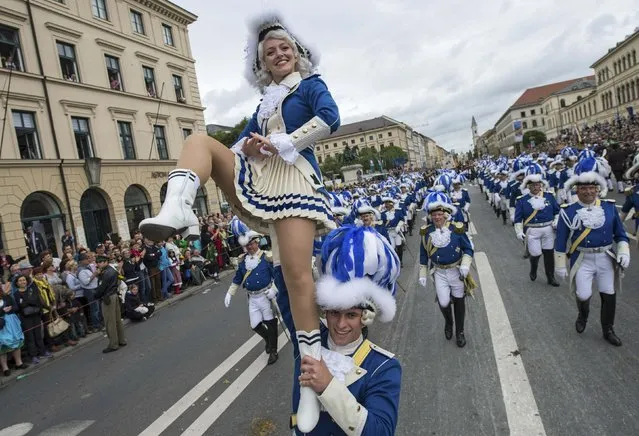 People dressed in traditional clothes take part in the Oktoberfest parade in Munich September 21, 2014. Millions of beer drinkers from around the world will come to the Bavarian capital over the next two weeks for the 181th Oktoberfest, which runs until October 5, 2014. (Photo by Lukas Barth/Reuters)