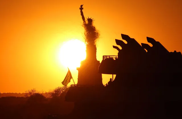 The sun sets behind the Statue of Liberty as it is partially obscurred by heat waves from the exhaust of a passing ferry on May 31, 2020 in New York City. (Photo by Gary Hershorn/Getty Images)