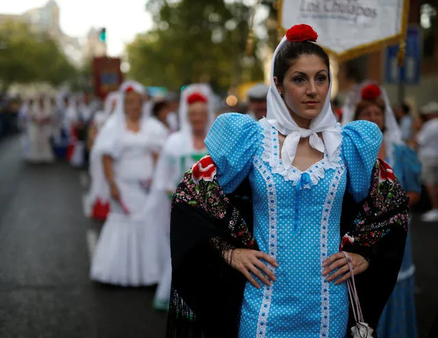 A woman dressed in Madrid's traditional attire “Chulapa” attends the Feast of La Paloma Virgin in Madrid,Spain, August 15, 2016. (Photo by Javier Barbancho/Reuters)