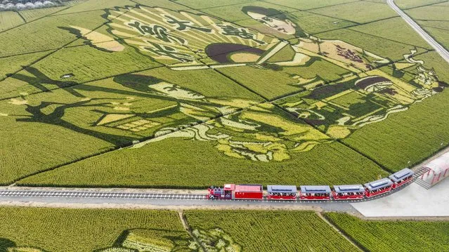 Aerial photo taken on October 1, 2022 shows tourists on a train driving through fields in Shanligezhuang Village of Zunhua, north China's Hebei Province. Saturday marks the first day of China's week-long National Day holiday. (Photo by Xinhua News Agency/Rex Features/Shutterstock)