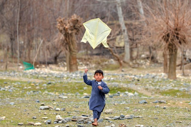An Afghan boy flies a kite at Fayzabad district in Badakhshan province on February 27, 2025. (Photo by Omer Abrar/AFP Photo)