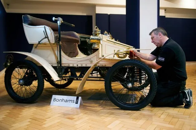 Bonhams employee Craig Binns polishes a, 1903 two seater moter car, the world oldest surviving Vauxhall, on November 1, 2012 in London, England. The Car is part of a Veteran Car Sale at Bonhams and is valued at around 80,000 pounds  (Photo by Bethany Clarke)