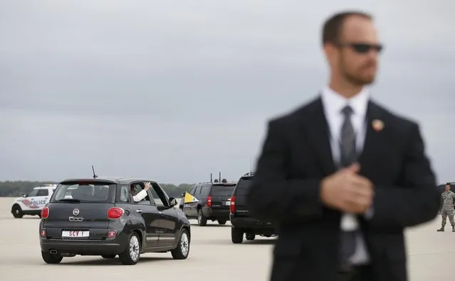With Secret Service personnel looking on, Pope Francis waves on departure at Joint Base Andrews, Maryland in a Fiat 500 after arriving for his first trip to the U.S. September 22, 2015. (Photo by Kevin Lamarque/Reuters)