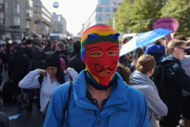 A Blockupy demonstrator wears a mask during a protest in front of the German labour ministry in Berlin, Germany September 2, 2016. (Photo by Stefanie Loos/Reuters)