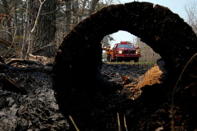 A firefighter works during a wildfire outbreak, in Forked River, in the Ocean County region of New Jersey on April 23, 2025. (Photo by Eduardo Munoz/Reuters)