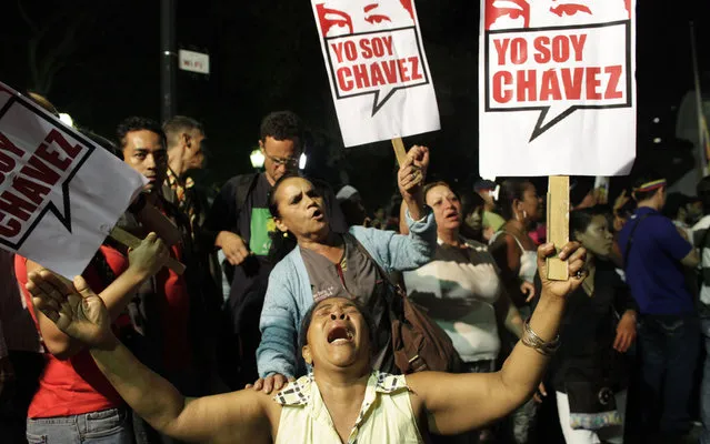 In the Plaza Bolivar in Caracas, Venezuela mourn the death of President Hugo Chavez. (Photo by Ariana Cubillos/AP Photo)