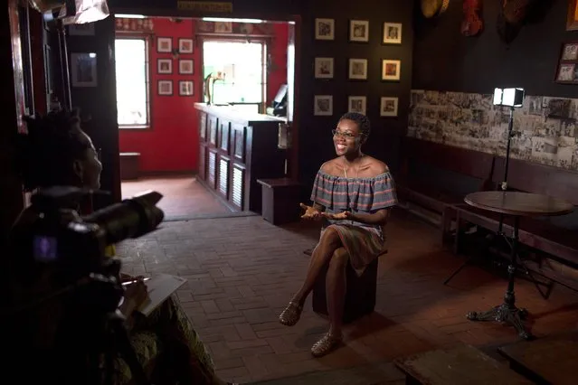 Artist Sena Ahadji speaks during an interview for an online streaming channel at the Republic Bar in Accra, Ghana, July 25, 2015. (Photo by Francis Kokoroko/Reuters)