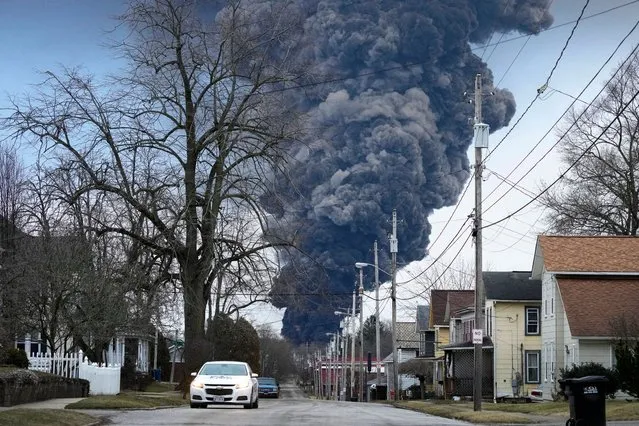 A black plume rises over East Palestine, Ohio, as a result of a controlled detonation of a portion of the derailed Norfolk Southern trains Monday, February 6, 2023. (Photo by Gene J. Puskar/AP Photo)