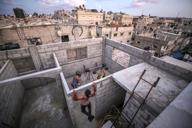 Palestinian bodybuilders work out on the rooftop of a house amid the ongoing coronavirus pandemic, in Rafah, southern Gaza strip, 04 October 2020 (issued 05 October 2020). The Gaza Strip has been under an emergency COVID-19 lockdown since 25 August 2020. (Photo by Mohammed Saber/EPA/EFE)