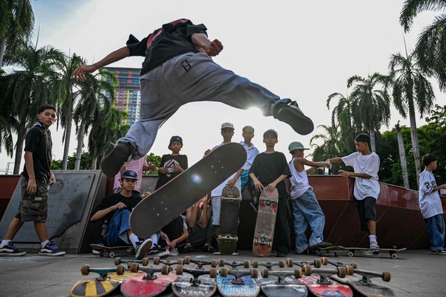 People watch as a skater performs during Go Skateboarding Day 2025 in Manila on June 21, 2025. (Photo by Jam Sta Rosa/AFP Photo)