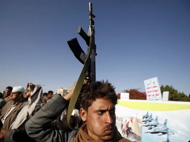 A follower of the Shi'ite Houthi movement holds his rifle during a demonstration to commemorate Ashura in Yemen's capital Sanaa October 24, 2015. Ashura, which falls on the 10th day of the Islamic month of Muharram, commemorates the death of Imam Hussein, grandson of Prophet Mohammad, who was killed in the seventh century battle of Kerbala. (Photo by Khaled Abdullah/Reuters)