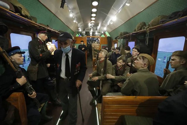 An elderly WWII veteran pass thru the 3D exhibition in the mobile museum “Victory Train” dedicated to the World War II at the Vitebsky railway station in St. Petersburg, Russia, 25 October 2020. The exhibition of the train is a complete composition consisting of eight themed railway cars. Visitors can see the peaceful pre-war life and everyday life of besieged Leningrad, find themselves in a real trench during the battle, help wounded soldiers, participate in the preparation of the offensive operation “Bagration”. The train runs through 13 Russia's cities and finishing in Volgograd. The exhibition will be held for 36 days and will be open until 27 October in St. Petersburg. (Photo by Anatoly Maltsev/EPA/EFE)