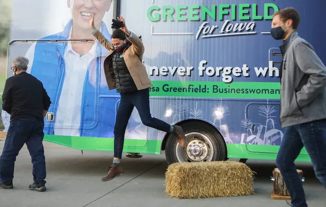 Democratic Senate candidate Theresa Greenfield jumps off a hay bale after speaking at a socially distanced drive-in campaign event as part of her resumed RV tour on October 29, 2020 in Winterset, Iowa. Greenfield briefly suspended the RV tour after learning staff members had come into contact with someone who tested positive for COVID-19. She resumed the tour today after testing negative for COVID-19 twice this week. Greenfield is in a tight race with Republican incumbent Sen. Joni Ernst (R-IA). (Photo by Mario Tama/Getty Images)