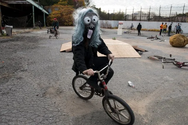A participant wears a mask while riding a bike during "Bike Kill 12" in the Brooklyn borough of New York City, October 31, 2015. (Photo by Stephanie Keith/Reuters)