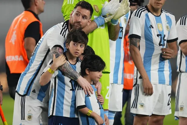 Argentina's Lionel Messi embraces his sons prior to an international friendly soccer match against Panama in Buenos Aires, Argentina, Thursday, March 23, 2023. (Photo by Natacha Pisarenko/AP Photo)