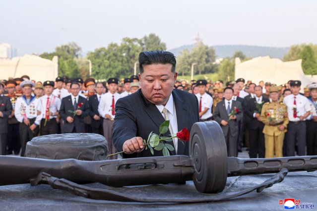 This picture taken on July 26, 2025 and released from North Korea's official Korean Central News Agency (KCNA) via KNS on July 27, 2025 shows North Korean leader Kim Jong Un (C) laying flowers at the Fatherland Liberation War Martyrs Cemetery on the 72nd anniversary of the armistice of the Korean War, in Pyongyang. (Photo by KCNA via KNS/AFP Photo)