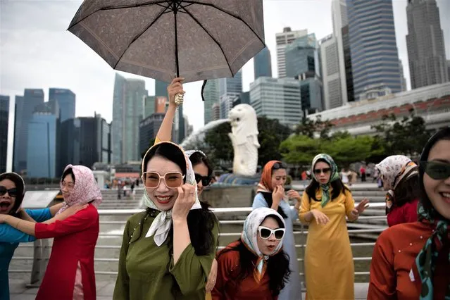 Tourists pose for photos in front of the Central Business District (BBD) skyline at Merlion Park in Singapore on 13 February 2023. According to data released by the Ministry of Trade and Industry (MTI), the Singapore economy expanded by 3.6 percent in 2022 and MTI maintains the GDP growth forecast for 2023 at a range of 0.5 to 2.5 percent. (Photo by How Hwee Young/EPA/EFE)
