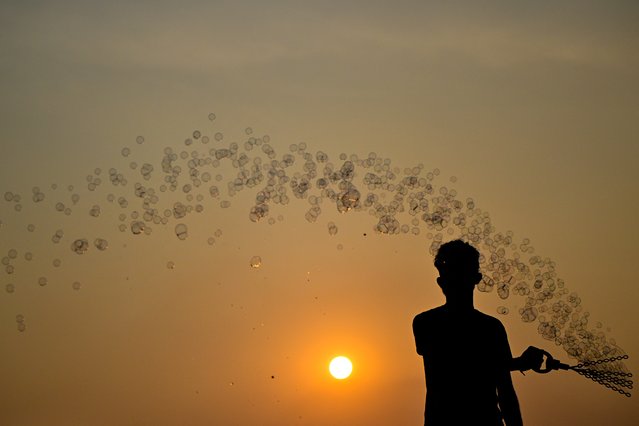 A vendor sells soap bubble toys at the Galle Face promenade in Colombo on February 21, 2025. (Photo by Ishara S. Kodikara/AFP Photo)