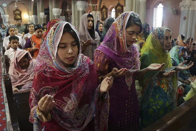 Pakistani Christians attend Easter service at Sacred Heart Cathedral, in Lahore, Pakistan, Sunday, April 1, 2018. Christians across the world are celebrating Easter, commemorating the day followers believe Jesus was resurrected in Jerusalem. (Photo by K.M. Chaudary/AP Photo)