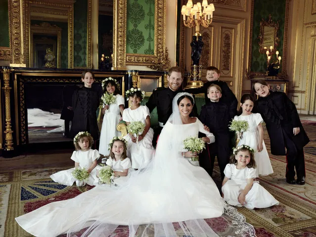 This official wedding photograph released by the Duke and Duchess of Sussex shows The Duke and Duchess in The Green Drawing Room, Windsor Castle, with (left-to-right): Back row: Master Brian Mulroney, Miss Remi Litt, Miss Rylan Litt, Master Jasper Dyer, Prince George, Miss Ivy Mulroney, Master John Mulroney. Front row: Miss Zalie Warren, Princess Charlotte, Miss Florence van Cutsem, May 19, 2018. (Photo by Alexi Lubomirski/Reuters)