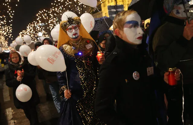 Members of the city's gay community hold candles as they walk in a procession to commemorate AIDS victims the day before World AIDS Day on November 30, 2015 in Berlin, Germany. According to a recent report released by UNAIDS, the number of worldwide cases fell in 2014 though AIDS remains the leading killer of teenaged males in Africa and AIDS cases are rising in countries across eastern Europe and the former Soviet Union, with the main means of transmission being heterosexual s*x. (Photo by Sean Gallup/Getty Images)