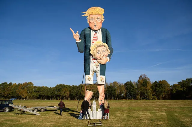 Members of the Edenbridge Bonfire Society work to assemble their creation ahead of a photocall to unveil this years “Celebrity Guy”, US Presidential candidate Donald Trump, on November 2, 2016 in Edenbridge, England. The Edenbridge Bonfire Society has created a large-scale effigy of a public figure for their annual bonfire for the last sixteen years, with previous names including cyclist Lance Armstrong, Iraqi leader Saddam Hussein, British Prime Minister Tony Blair and comedian and activist Russell Brand. (Photo by Leon Neal/Getty Images)