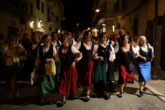 A folklore choir group from the town of Castel del Monte in Abruzzo performs in the town of Vieste in the province of Foggia, Puglia, Italy, September 17, 2016. (Photo by Siegfried Modola/Reuters)