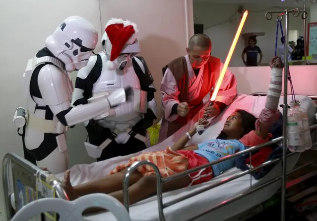 Cosplayers dressed as characters from the Star Wars movie series visit patients during a charity event organised by non-profit group 501st Legion, at East Avenue Medical Center in Quezon city, metro Manila  December 6, 2015. (Photo by Romeo Ranoco/Reuters)