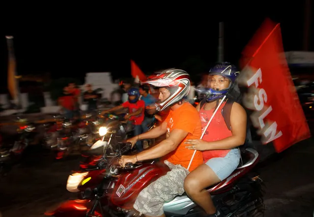 Supporters of Nicaragua's President Daniel Ortega and vice presidential candidate, his wife, Rosario Murillo ride with flags of the Sandinista National Liberation Front, or FSLN, while celebrating after preliminary results showed Ortega was on course for reelection, in Managua, Nicaragua November 6, 2016. (Photo by Oswaldo Rivas/Reuters)
