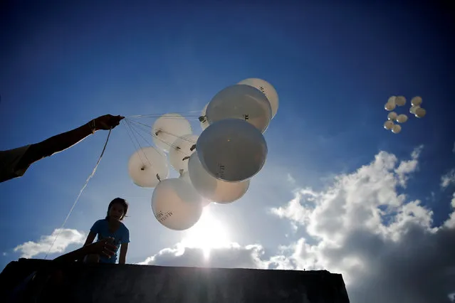 Balloons are released during funeral of 7-year-old Mariamela C. Ramos at Tugatog public cemetery where she was killed earlier this month, in Manila, Philippines October 29, 2016. (Photo by Damir Sagolj/Reuters)