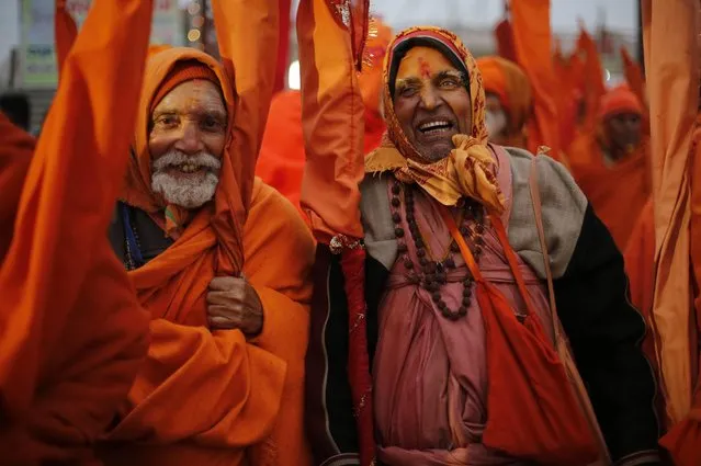 Indian Sadhus, or Hindu holy men, participate in a community feast at the Sangam, the confluence of the Rivers Ganges, Yamuna and mythical Saraswati, during the annual month-long Magh Mela religious fair in Allahabad, India, Friday, January 16, 2015. (Photo by Rajesh Kumar Singh/AP Photo)