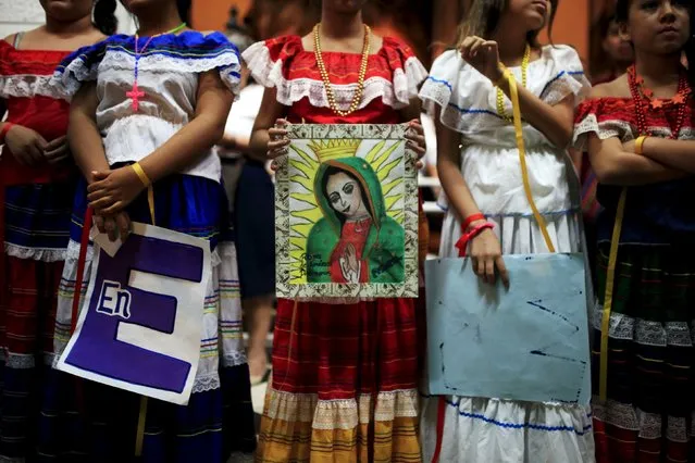 Girls participate in a ceremony to celebrate the Day of the Virgin of Guadalupe inside the Basilica of Guadalupe in San Salvador, El Salvador December 11, 2015. (Photo by Jose Cabezas/Reuters)