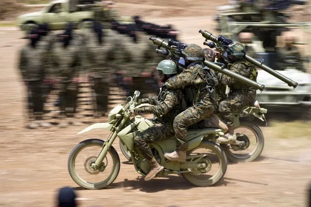 Fighters from the Lebanese militant group Hezbollah ride their motorcycles during a training exercise in Aaramta village in the Jezzine District, southern Lebanon, Sunday, May 21, 2023. (Photo by Hassan Ammar/AP Photo)