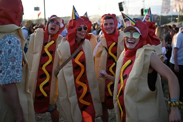Festivalgoers dressed in hotdog outfits react in the Silver Hayes area  on Day 2 of the Glastonbury festival in the village of Pilton in Somerset, southwest England, on June 22, 2023. The festival takes place from June 21 to June 26. (Photo by Oli Scarff/AFP Photo)
