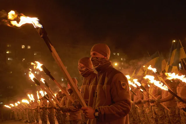 Members of ultra-nationalist paramilitary Ukrainian group Azov march to Lenin square in Mariupol to attend a ceremony to unveil a new monument on December 20, 2015 in Mariupol, Ukraine. The monument was dedicated to Ukrainian hero Svyatoslav and replaced a Lenin statue. (Photo by Pierre Crom/Getty Images)